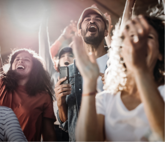 Happy fans cheer in a stadium